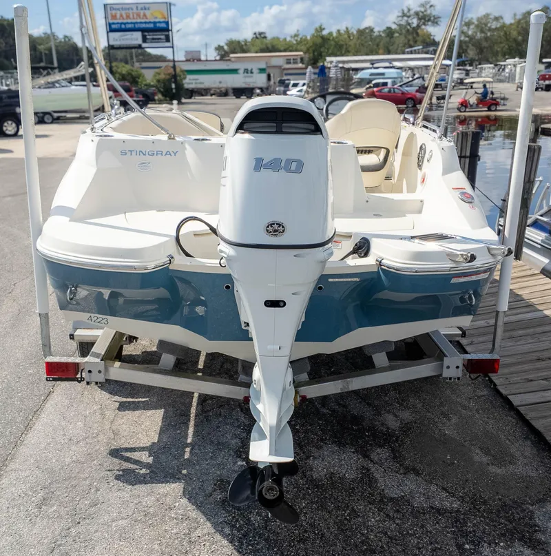 Slide: The Image of 2021 Stingray 192SC boat with 140 horsepower engine, docked at marina. - 4