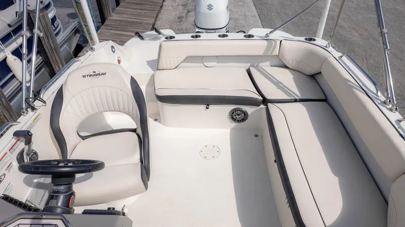 Slide: The Image of 2021 Stingray 192SC boat interior with beige seating and steering wheel. - 8