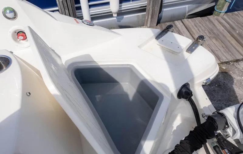 Slide: The Image of 2021 Stingray 192SC boat storage compartment open at dockside. - 9
