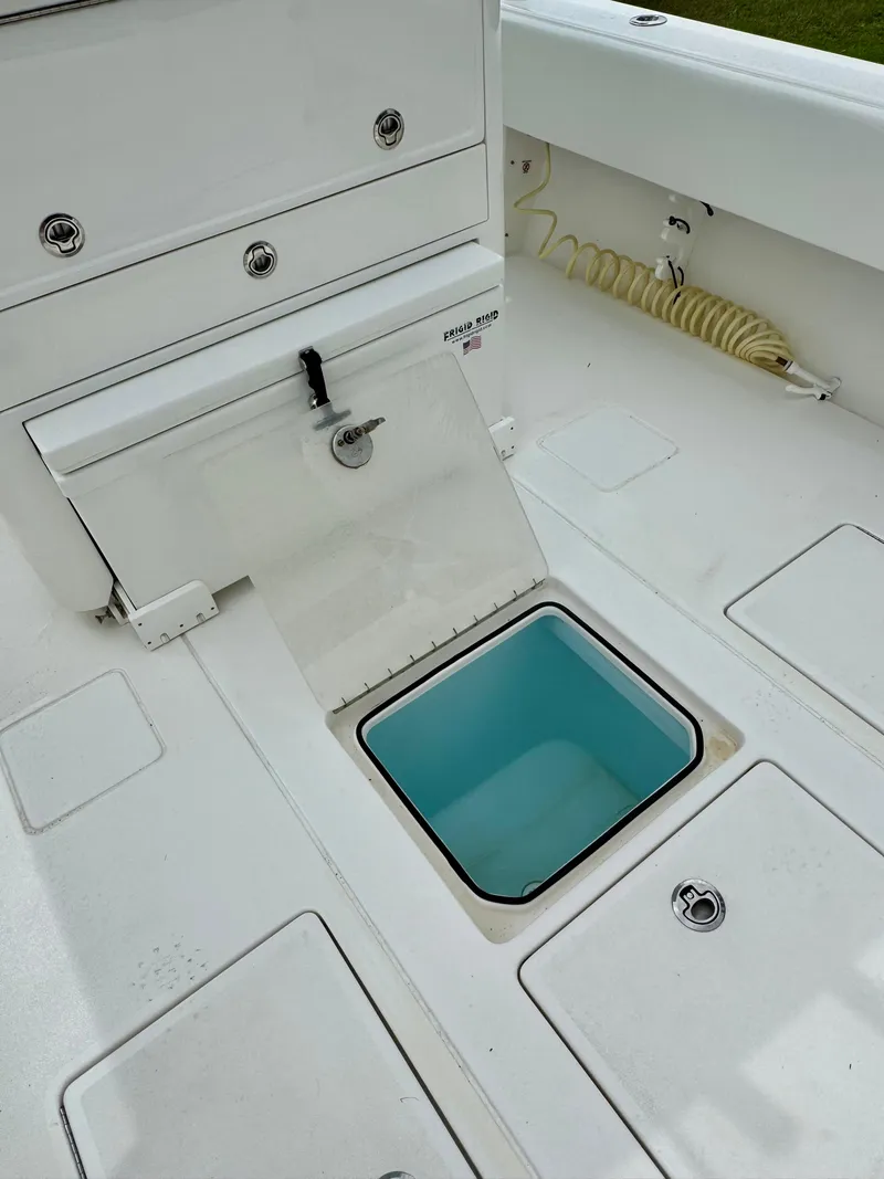 Slide: The Image of 2023 Contender 35ST boat deck with open storage compartment. - 10