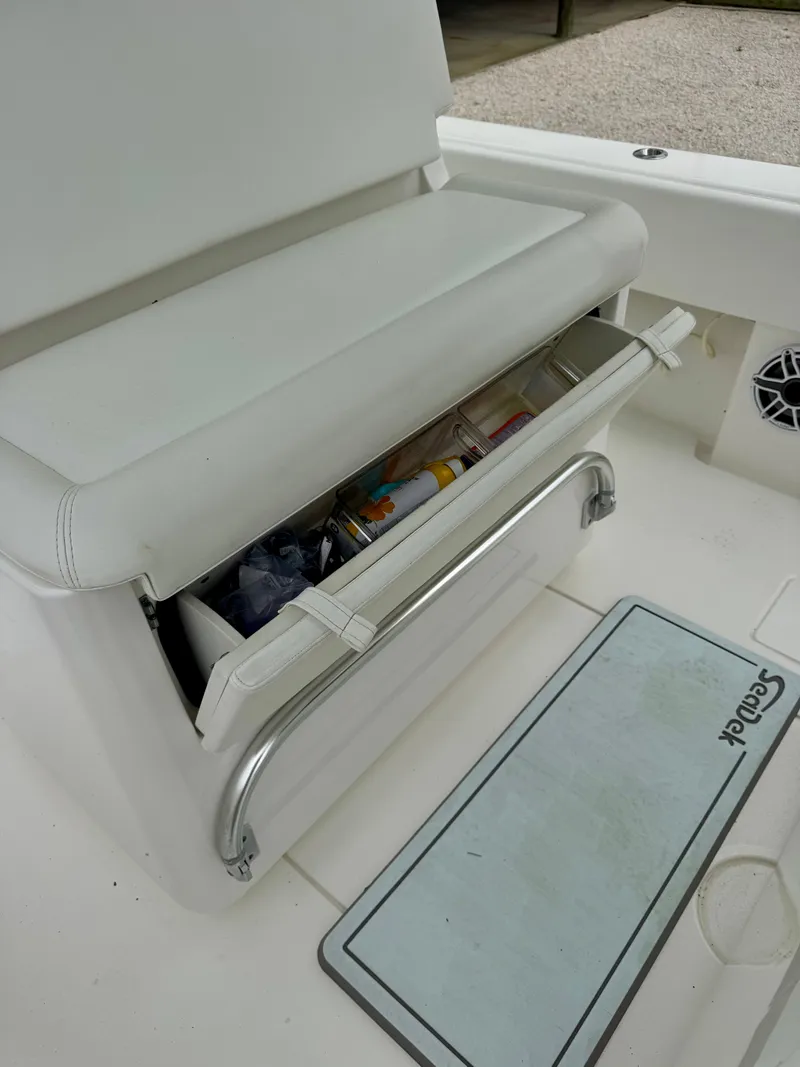 Slide: The Image of 2023 Contender 35ST boat with open storage compartment and cushioned seating. - 15