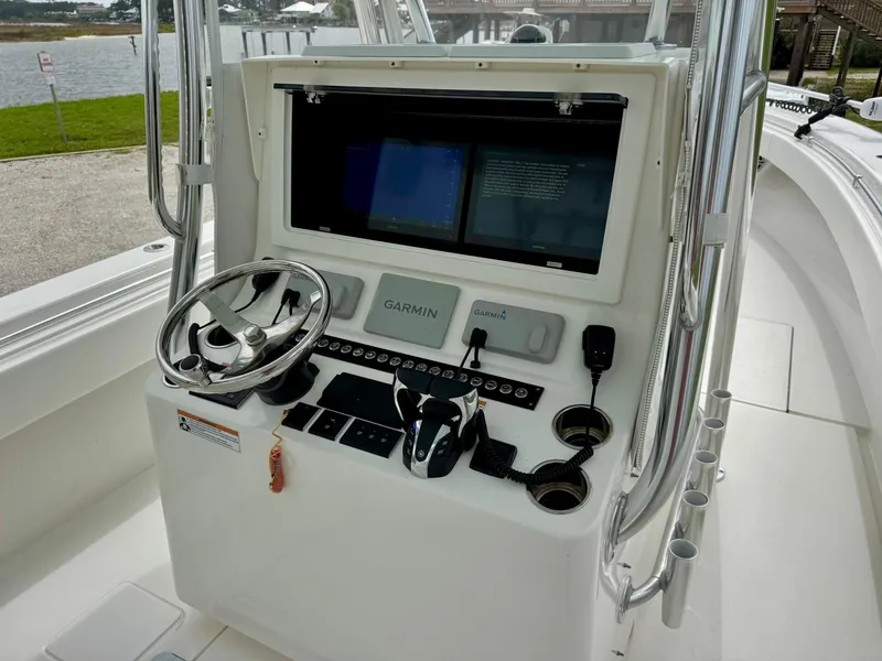 Slide: The Image of 2023 Contender 35ST boat console with Garmin navigation system and steering wheel. - 17