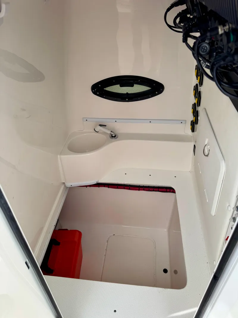 Slide: The Image of 2023 Contender 35ST interior cabin with storage and porthole window. - 24