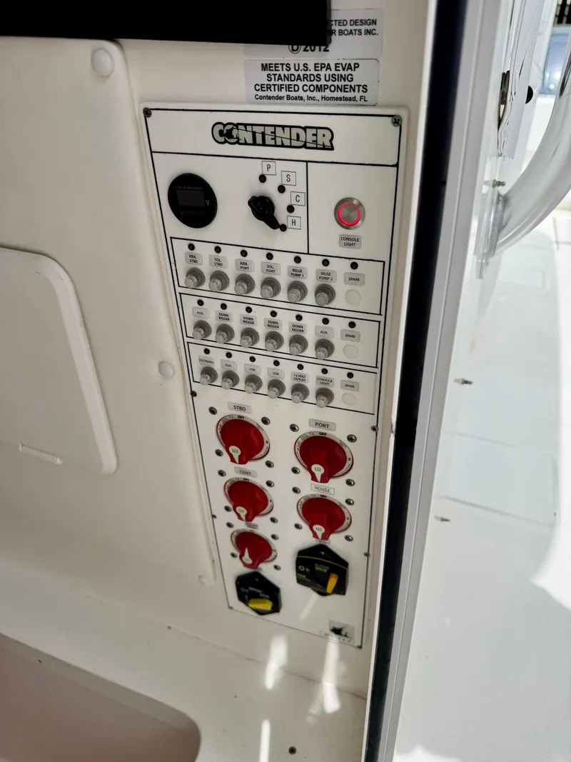 Slide: The Image of Control panel of 2023 Contender 35ST boat with switches and dials. - 25