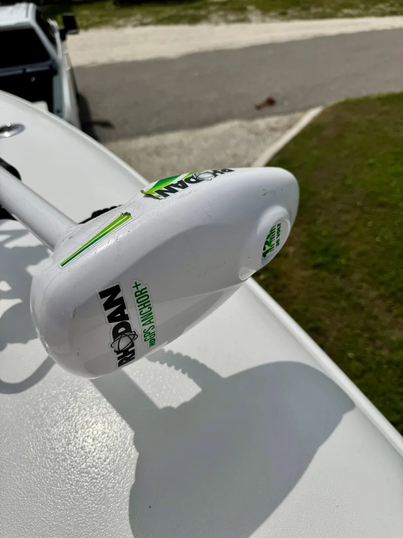 Slide: The Image of 2023 Contender 35ST boat with Minn Kota trolling motor, parked on a sunny day. - 29