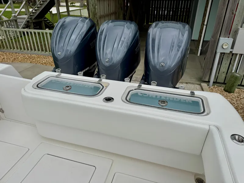 Slide: The Image of 2023 Contender 35ST boat with triple outboard engines and dual livewells. - 7