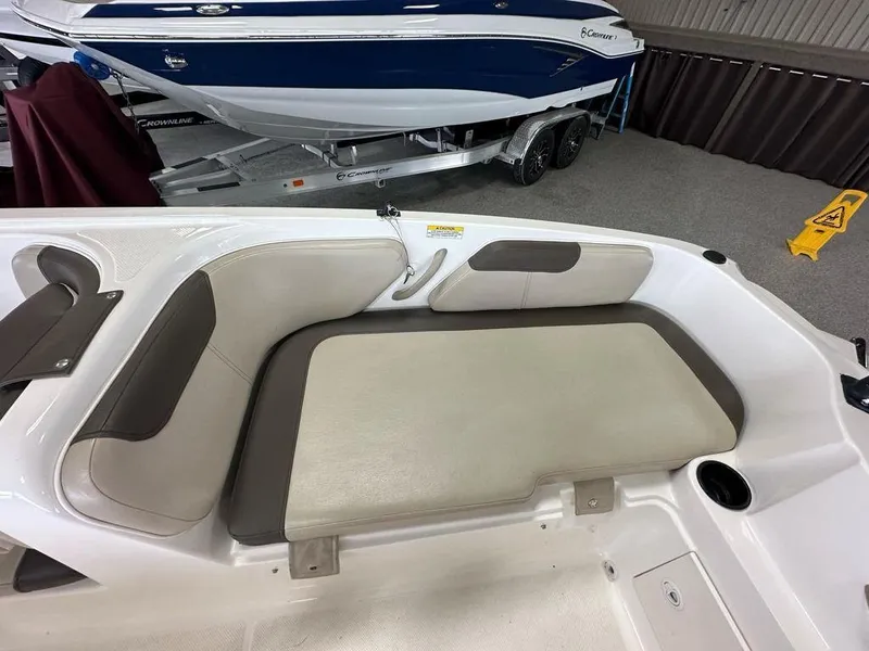 Slide: The Image of Interior seating of a 2017 Bayliner Element 18 boat, featuring beige and brown upholstery. - 14