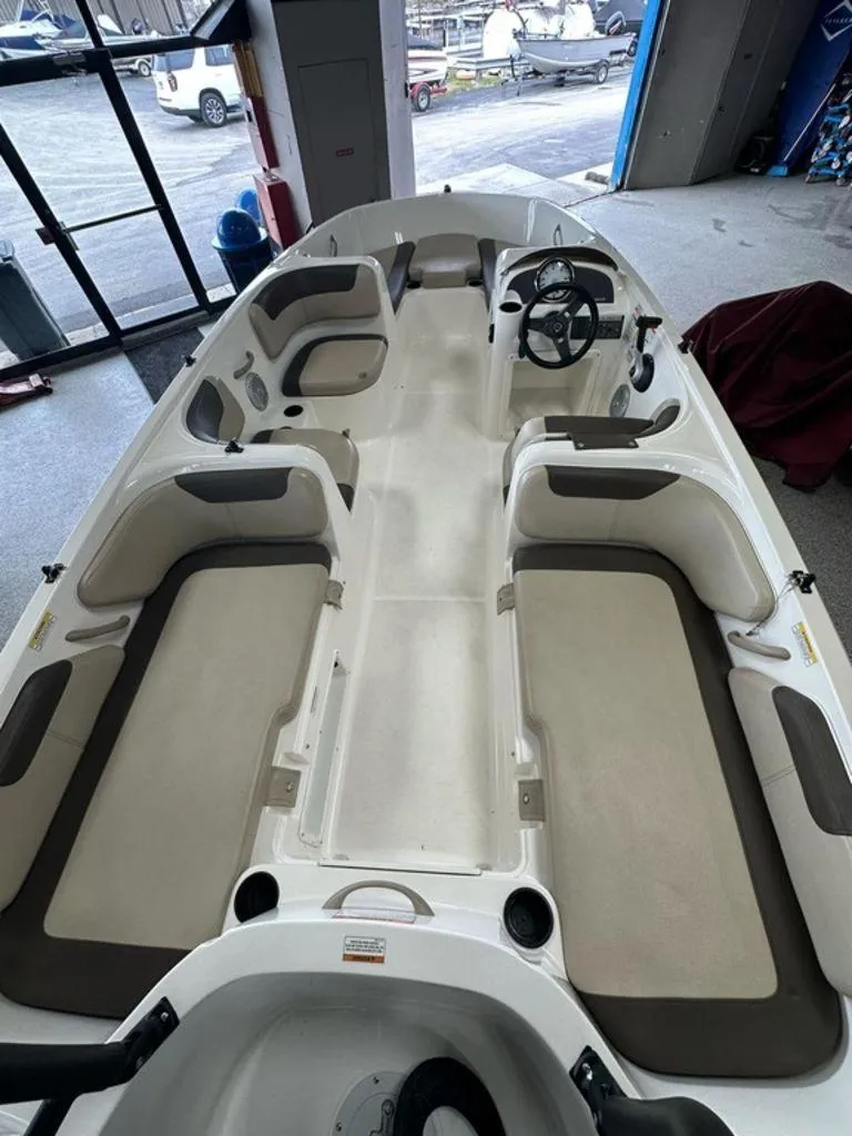 Slide: The Image of 2017 Bayliner Element 18 boat interior with spacious seating and steering wheel. - 2