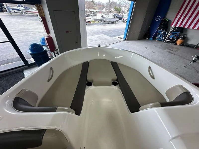 Slide: The Image of 2017 Bayliner Element 18 boat interior with seating, displayed in a showroom. - 3