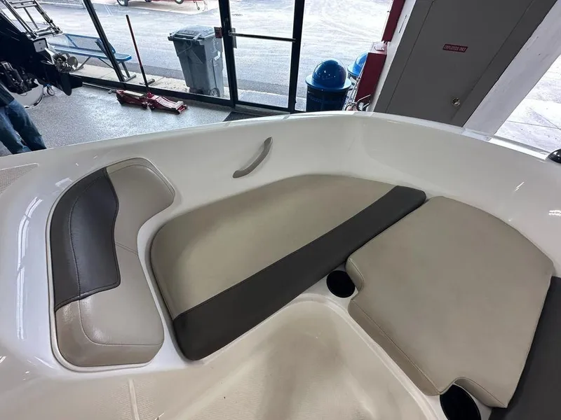 Slide: The Image of Interior seating of a 2017 Bayliner Element 18 boat, featuring beige and gray cushions. - 5