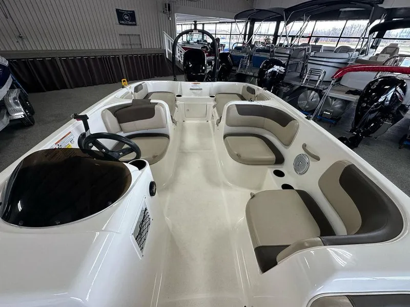 Slide: The Image of 2017 Bayliner Element 18 boat interior with seating and steering wheel in showroom. - 6