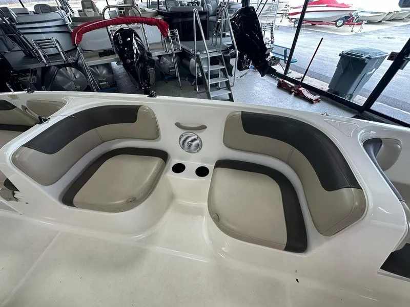 Slide: The Image of 2017 Bayliner Element 18 boat interior with cushioned seating and cup holders. - 7