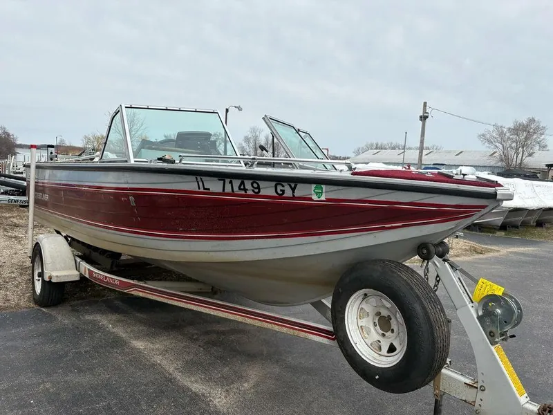 Slide: The Image of 1988 Crestliner Nordic 18 boat on trailer, red and white, parked outdoors. - 2