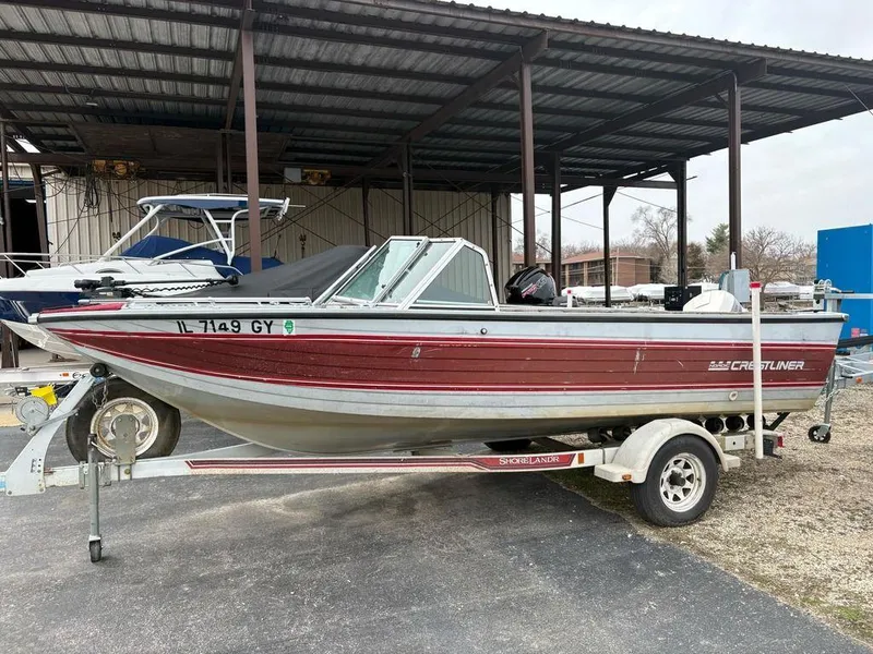 Slide: The Image of 1988 Crestliner Nordic 18 boat on trailer, parked under a metal canopy. - 3