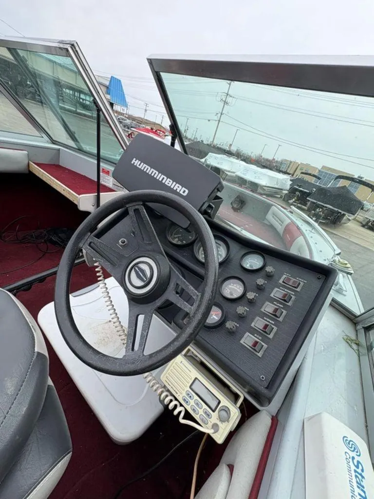 Slide: The Image of 1988 Crestliner Nordic 18 boat dashboard with steering wheel and control panel. - 5