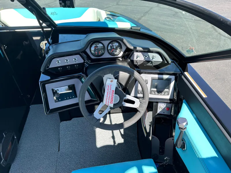 Slide: The Image of 2022 MasterCraft NXT20 boat dashboard with steering wheel and control panel. - 12