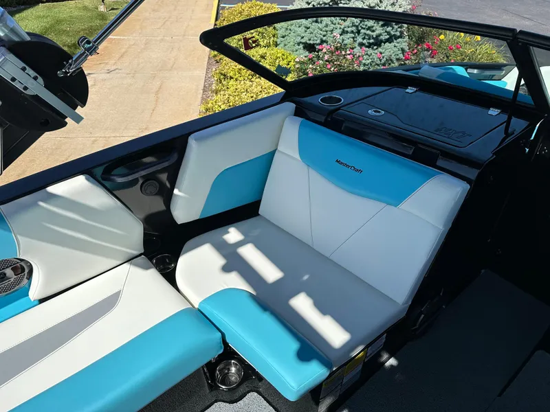 Slide: The Image of 2022 MasterCraft NXT20 boat interior with blue and white seating. - 13