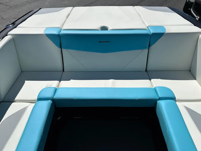 Slide: The Image of 2022 MasterCraft NXT20 boat interior with white and blue seating. - 15