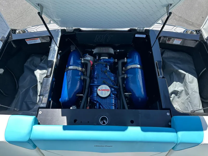 Slide: The Image of 2022 MasterCraft NXT20 engine compartment with Ilmor engine, open hatch view. - 19