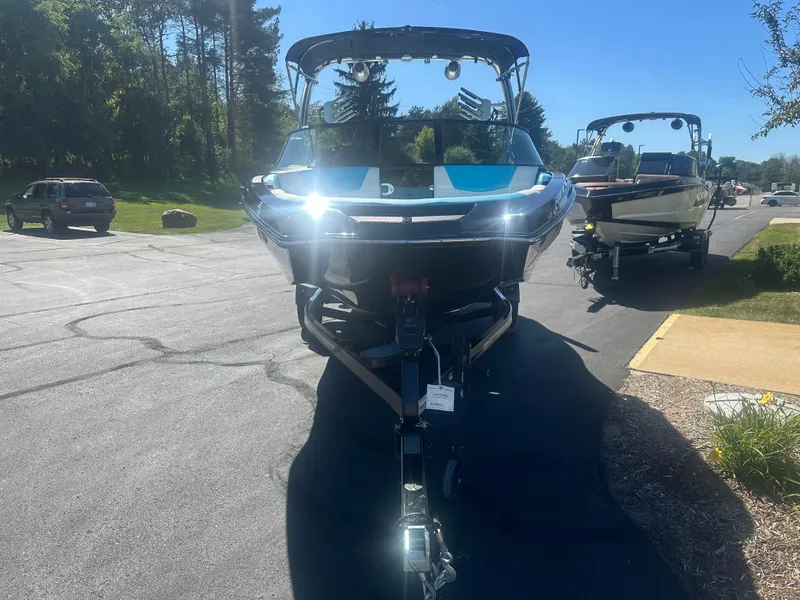 Slide: The Image of 2022 MasterCraft NXT20 boat on trailer in sunny parking lot. - 3