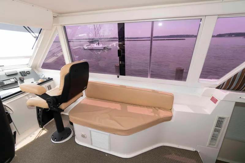 Slide: The Image of Interior of 1999 Viking 60 Cockpit Motor Yacht with seating and ocean view. - 16