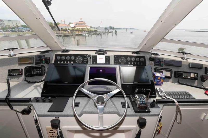 Slide: The Image of 1999 Viking 60 Cockpit Motor Yacht helm with modern navigation equipment and panoramic view. - 17
