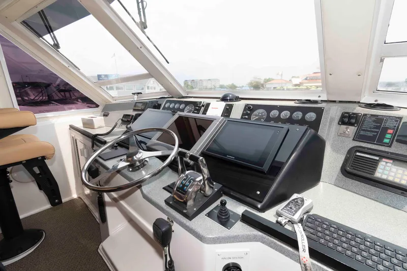 Slide: The Image of Cockpit of 1999 Viking 60 Cockpit Motor Yacht with steering wheel and navigation controls. - 18