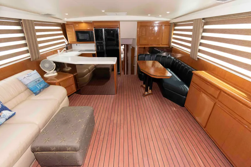 Slide: The Image of Interior of 1999 Viking 60 Cockpit Motor Yacht with modern furnishings and wood flooring. - 20