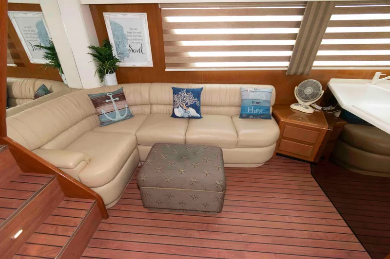 Slide: The Image of Luxurious interior of 1999 Viking 60 Cockpit Motor Yacht with beige seating and nautical decor. - 22