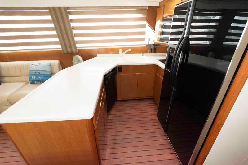 Slide: The Image of Interior of 1999 Viking 60 Cockpit Motor Yacht with modern kitchen and sleek design. - 25