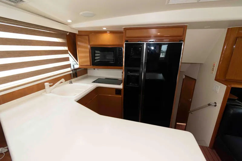 Slide: The Image of Interior of 1999 Viking 60 Cockpit Motor Yacht kitchen with modern appliances and sleek design. - 29