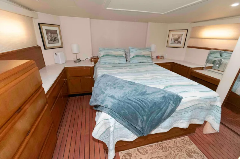 Slide: The Image of Cozy bedroom in 1999 Viking 60 Cockpit Motor Yacht with wood flooring and elegant decor. - 30