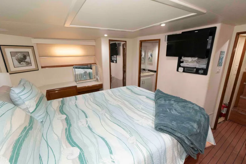 Slide: The Image of Luxurious bedroom interior of 1999 Viking 60 Cockpit Motor Yacht with modern amenities. - 32