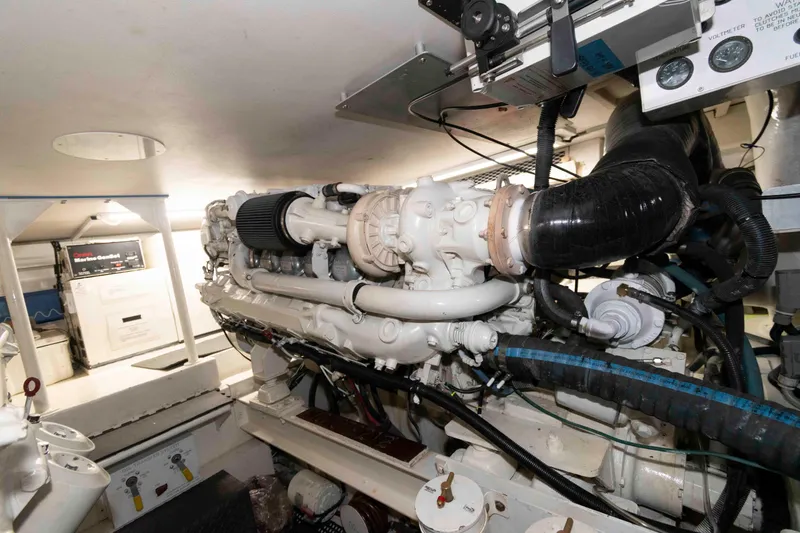 Slide: The Image of Engine room of 1999 Viking 60 Cockpit Motor Yacht, showcasing complex machinery and components. - 42