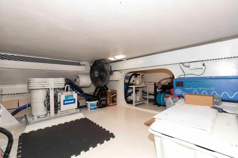 Slide: The Image of Engine room of 1999 Viking 60 Cockpit Motor Yacht with equipment and storage. - 45