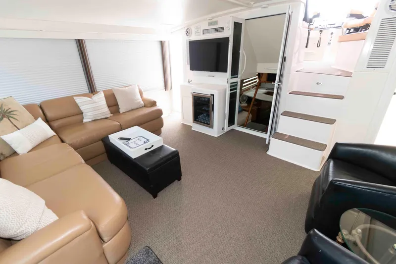 Slide: The Image of Luxurious interior of 1999 Viking 60 Cockpit Motor Yacht with leather seating and modern amenities. - 9