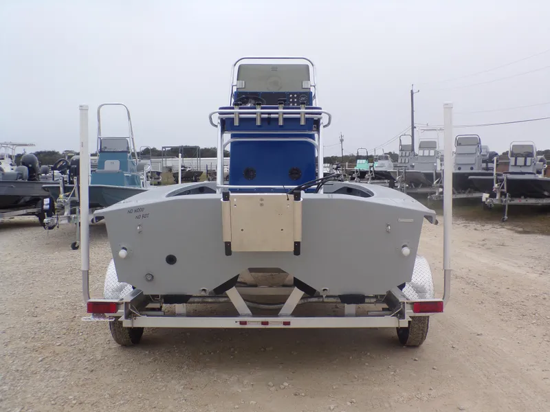 Slide: The Image of 2025 Freedom Warrior 23 boat on trailer, rear view, in a boatyard. - 10