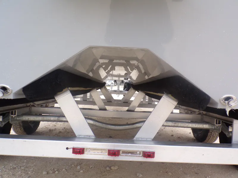 Slide: The Image of Trailer view of 2025 Freedom Warrior 23 boat, showcasing hull and support structure. - 11