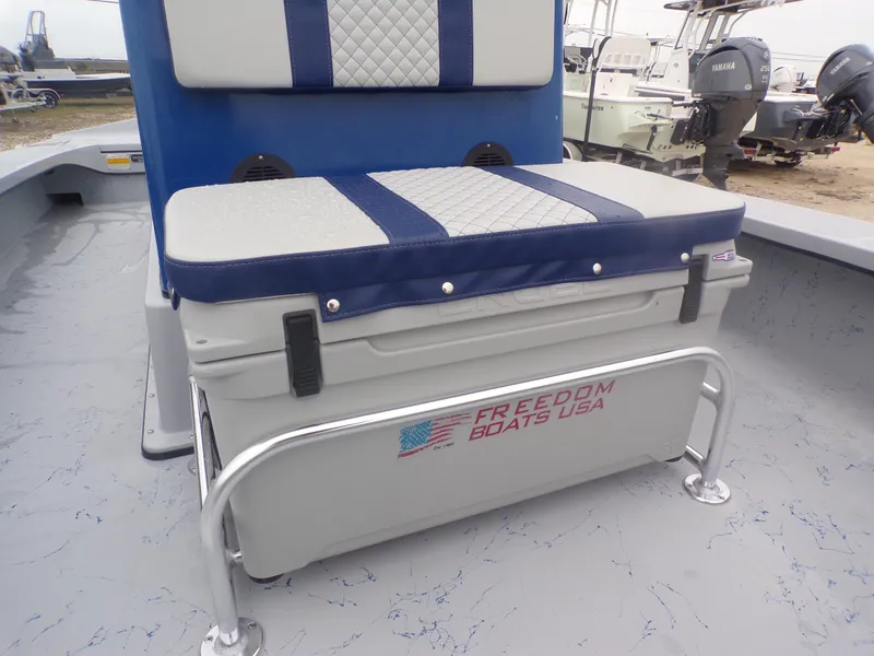 Slide: The Image of 2025 Freedom Warrior 23 boat seat with storage, featuring blue and white cushioned design. - 15