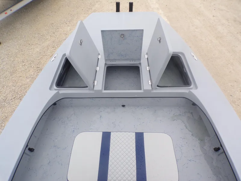 Slide: The Image of 2025 Freedom Warrior 23 boat interior with open storage compartments and cushioned seating. - 17