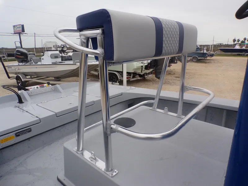 Slide: The Image of Freedom Warrior 23 boat seat with metal frame, 2025 model, in a boatyard setting. - 20