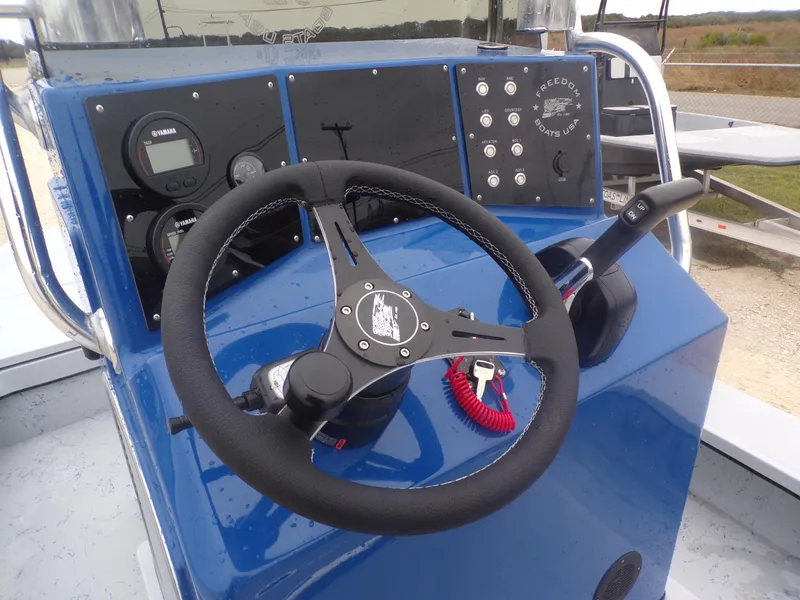Slide: The Image of Steering console of 2025 Freedom Warrior 23 boat with gauges and controls. - 25