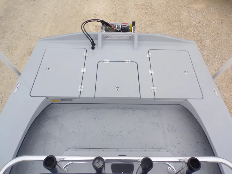 Slide: The Image of 2025 Freedom Warrior 23 boat deck with storage compartments and control panel. - 28