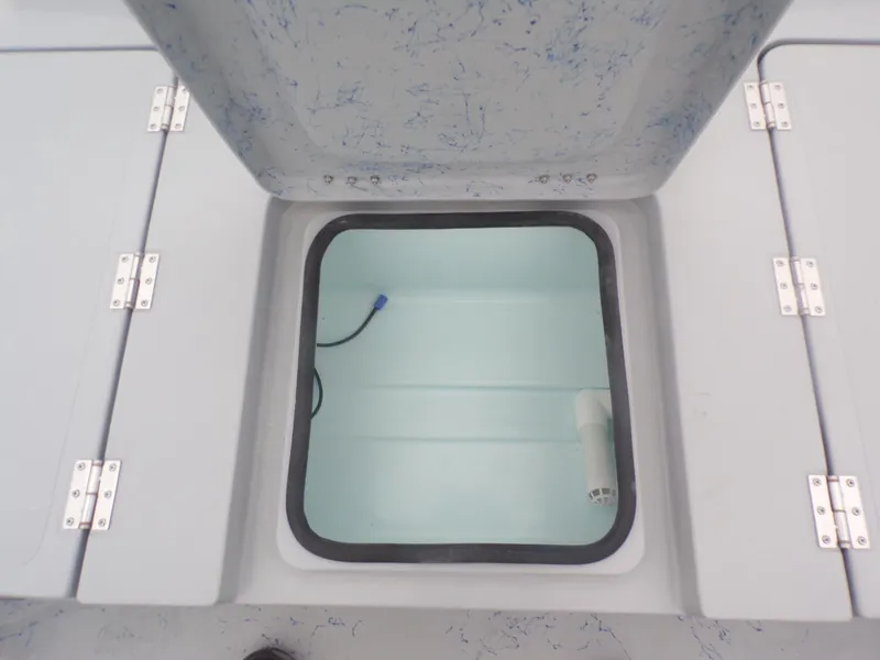 Slide: The Image of Open storage compartment on a 2025 Freedom Warrior 23 boat, featuring a clean interior. - 29