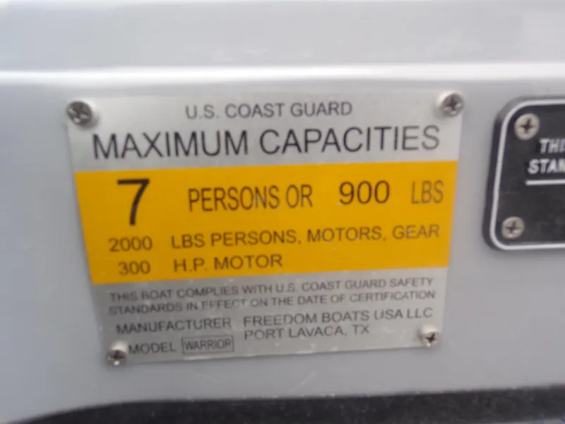 Slide: The Image of Freedom Warrior 23 boat capacity label, 7 persons or 900 lbs, 2025 model. - 31