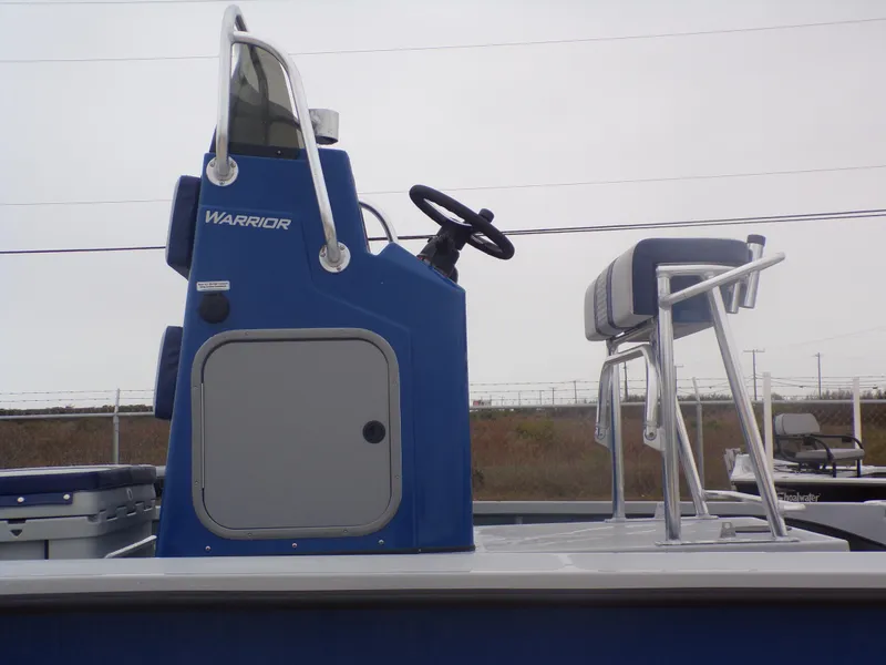 Slide: The Image of 2025 Freedom Warrior 23 boat console with steering wheel and seating, side view. - 36