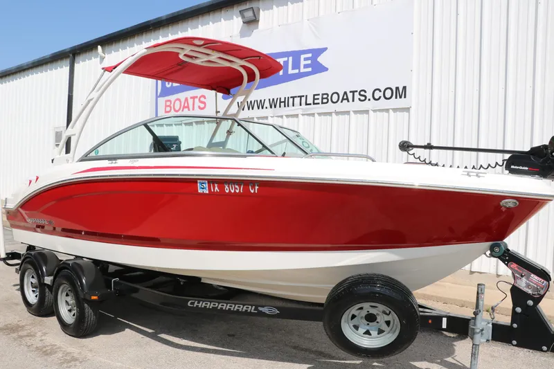 Slide: The Image of 2014 Chaparral 21 H2O Ski & Fish boat in red, on trailer, parked outside dealership. - 10