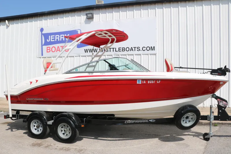 Slide: The Image of 2014 Chaparral 21 H2O Ski & Fish boat, red and white, on trailer outside dealership. - 13