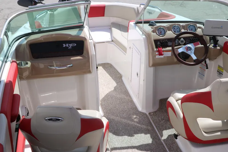 Slide: The Image of 2014 Chaparral 21 H2O Ski & Fish boat interior with steering wheel and seating. - 18