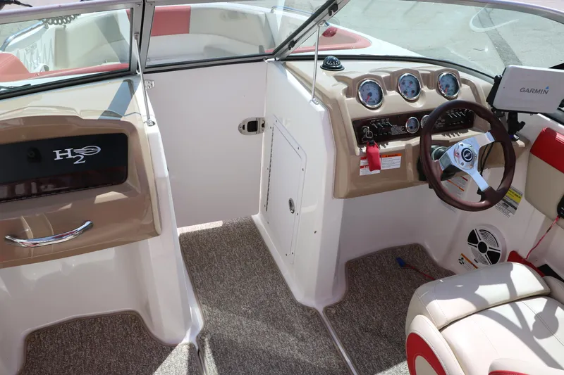 Slide: The Image of 2014 Chaparral 21 H2O Ski & Fish boat interior with steering wheel and dashboard controls. - 26
